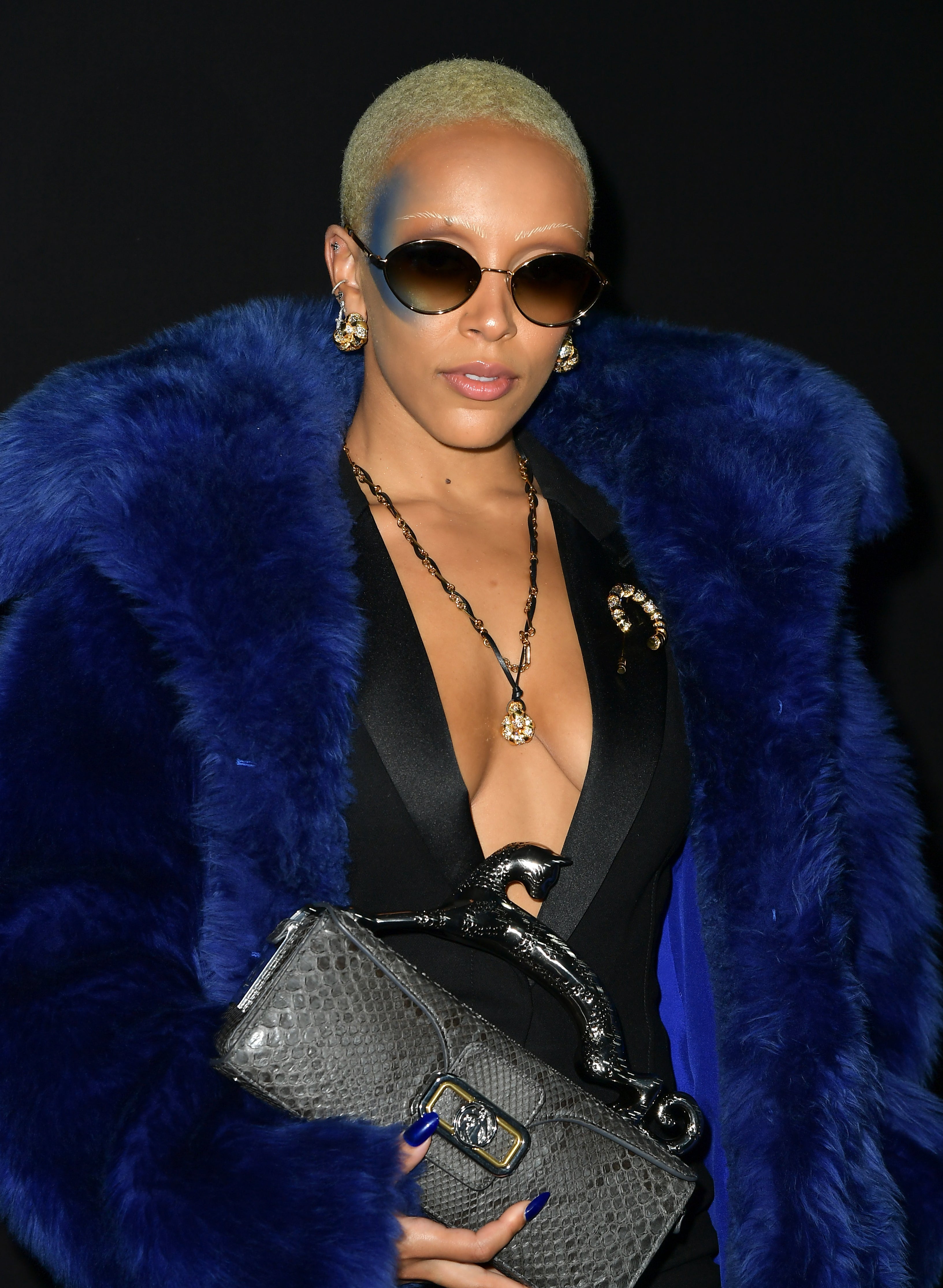 A close-up of Doja wearing sunglasses and a furry coat