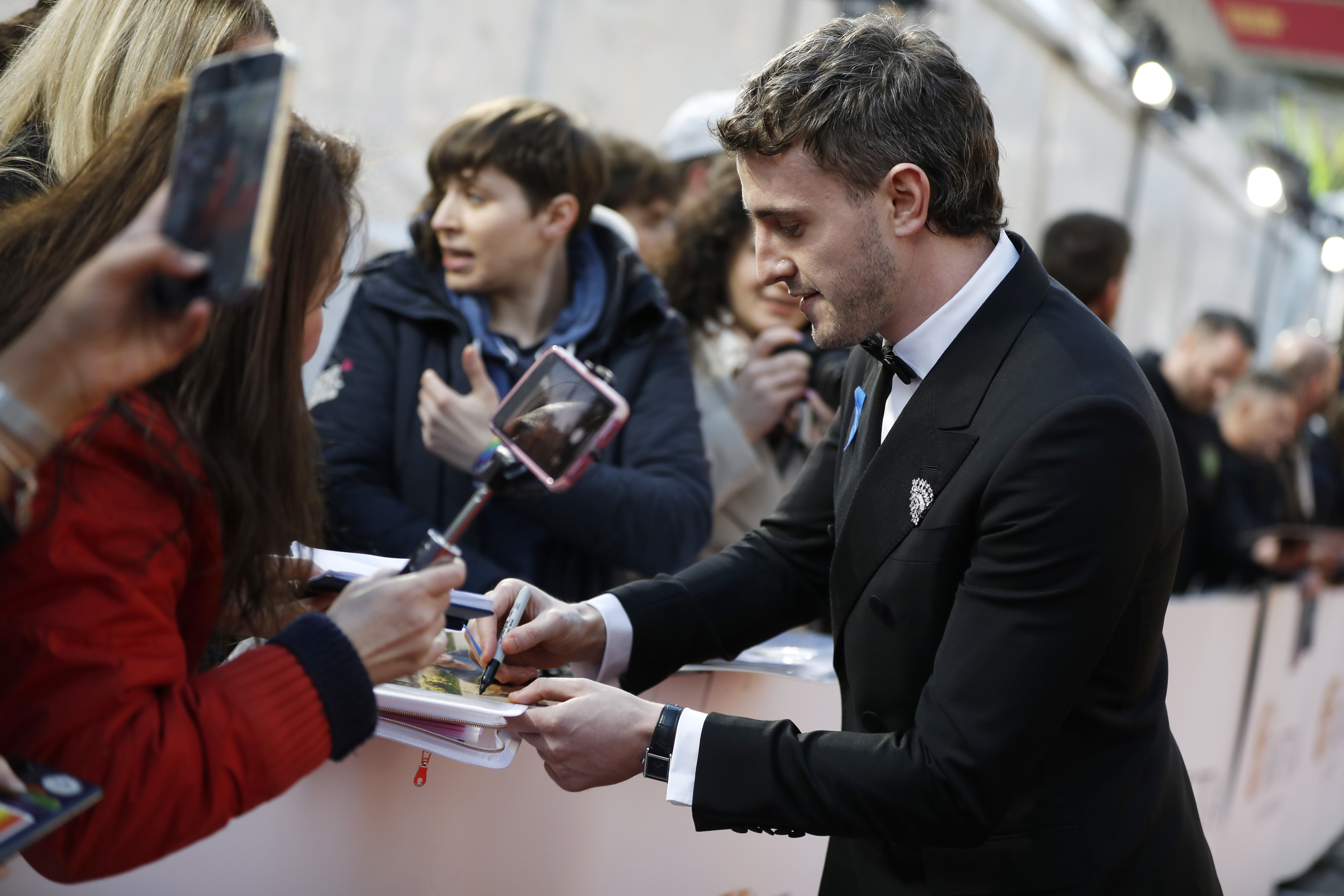 Close-up of Paul signing autographs