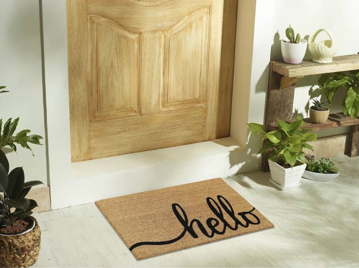 Hello doorway mat successful beforehand of a woody beforehand door