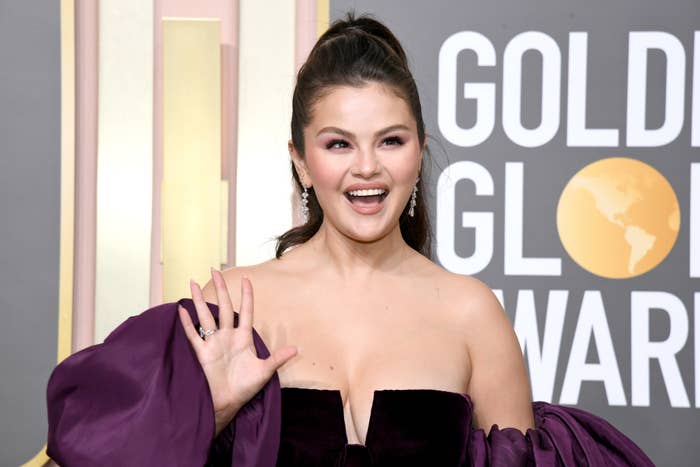 Close-up of Selena smiling and waving at a media event