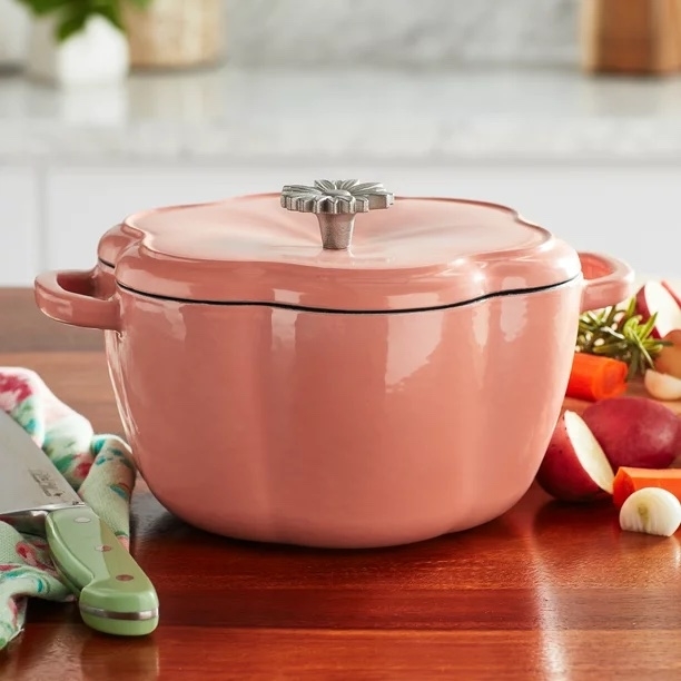 Pink Dutch oven on a wood countertop
