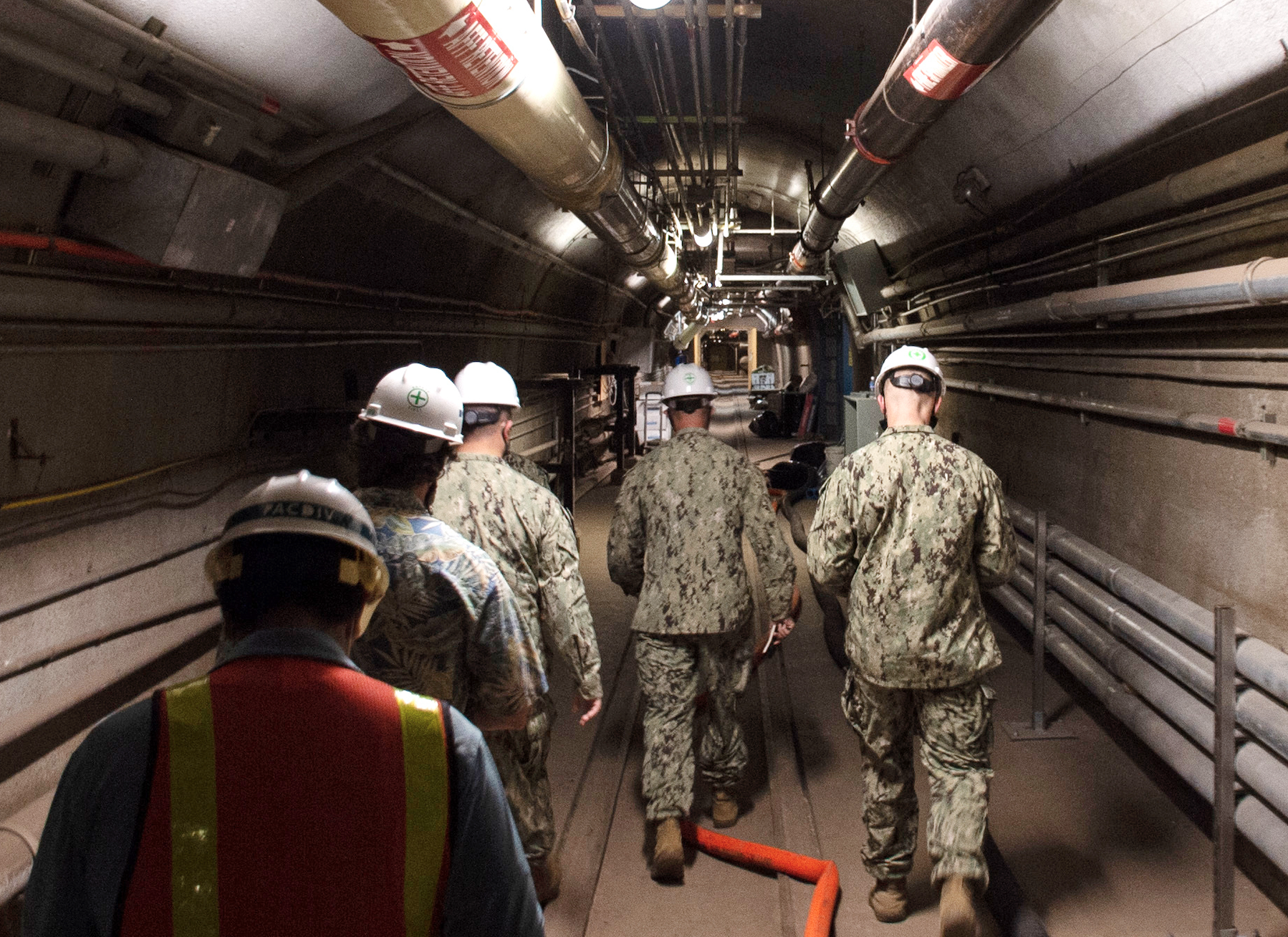 Soldiers walking through a tunnel