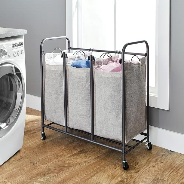 Gray hamper on wheels in a laundry room