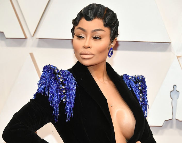 Blac Chyna on the red carpet wearing an embellished jacket with nothing underneath