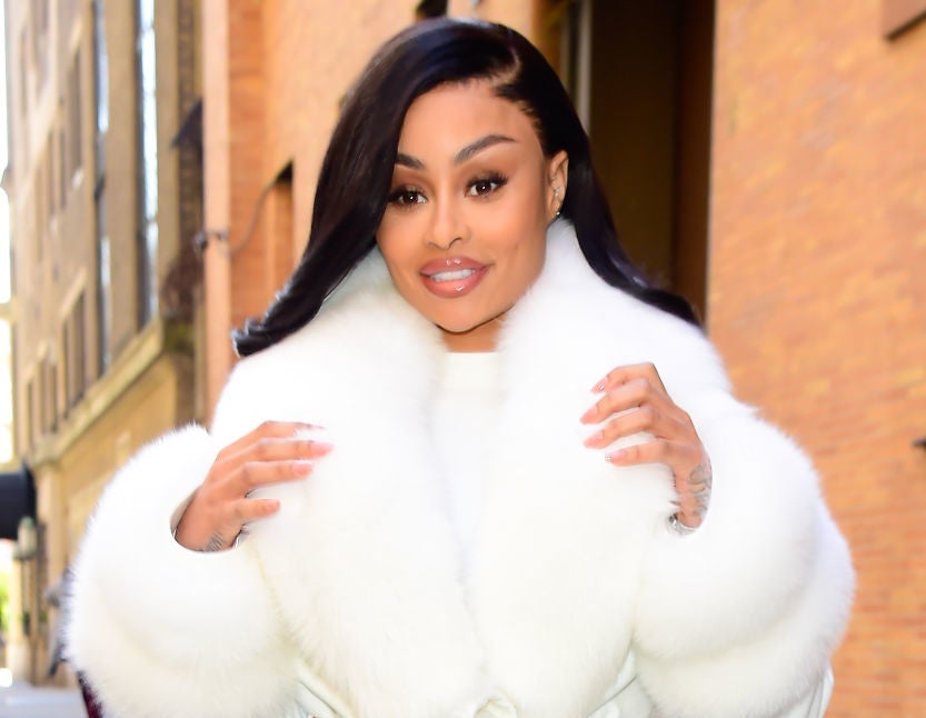 A closeup of Blac Chyna walking outside in a furry coat