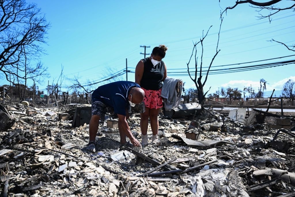 Displaced citizens picking through the rubble of the Maui aftermath