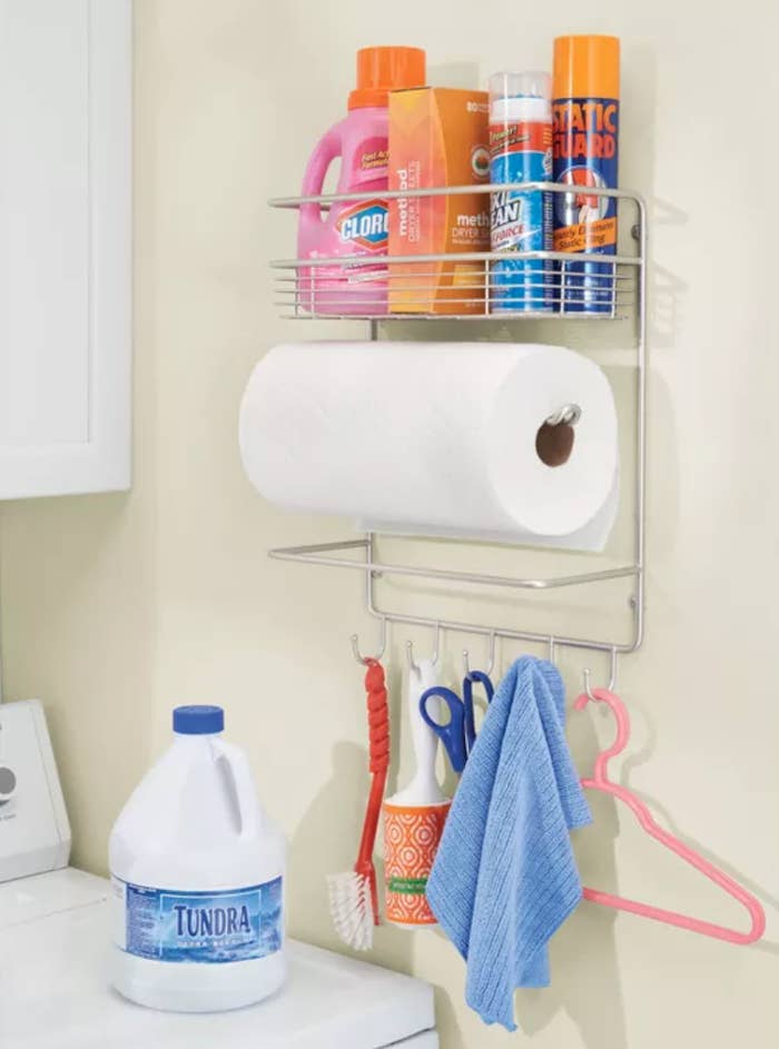 a wall mounted paper towel roll with hooks