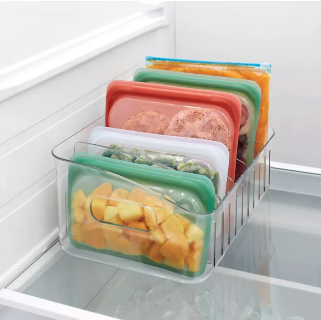 a freezer bin holding a variety of food in colored freezer bags