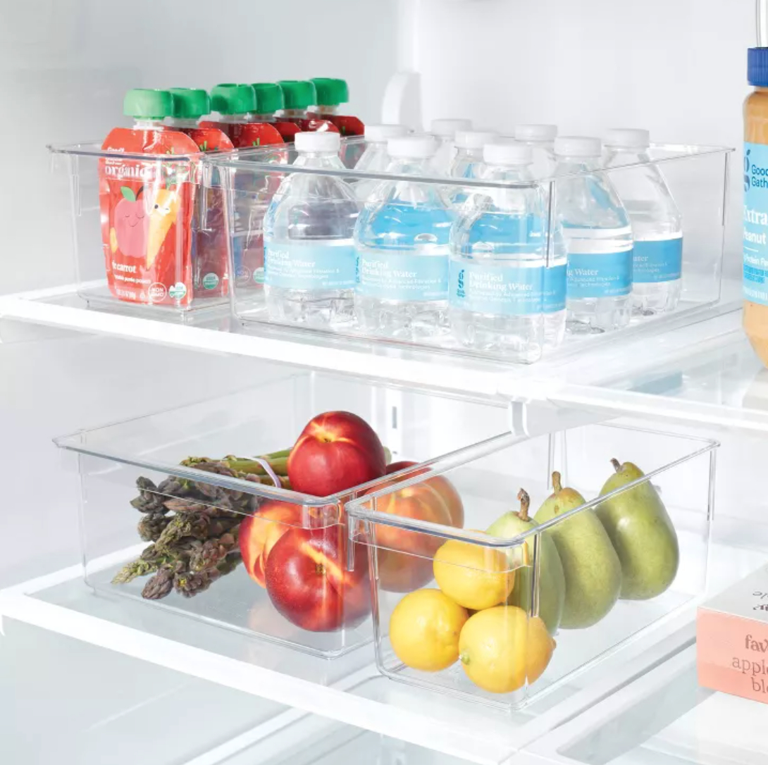 plastic fridge bins holding fruit, veggies, water bottles, and juice boxes