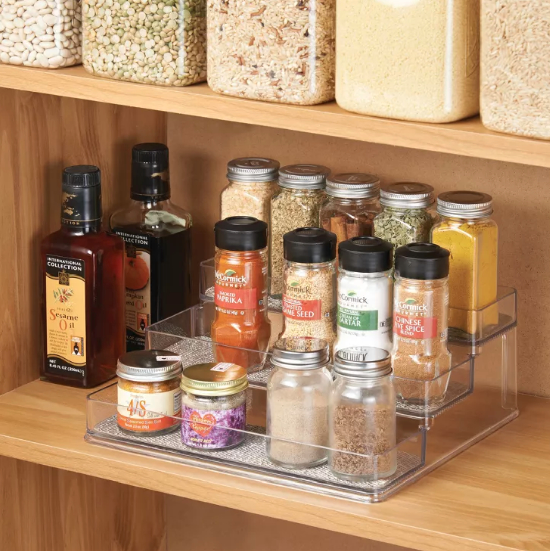 a three-tiered spice rack in a cabinet