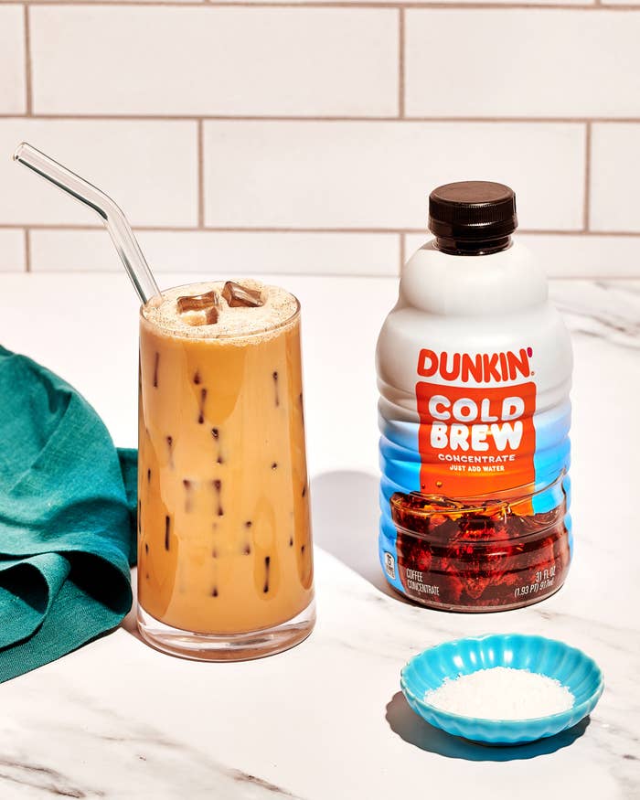 dunkin cold brew concentrate product imagery alongside a glass of Salted Vanilla Cold Brew and small dish of salt