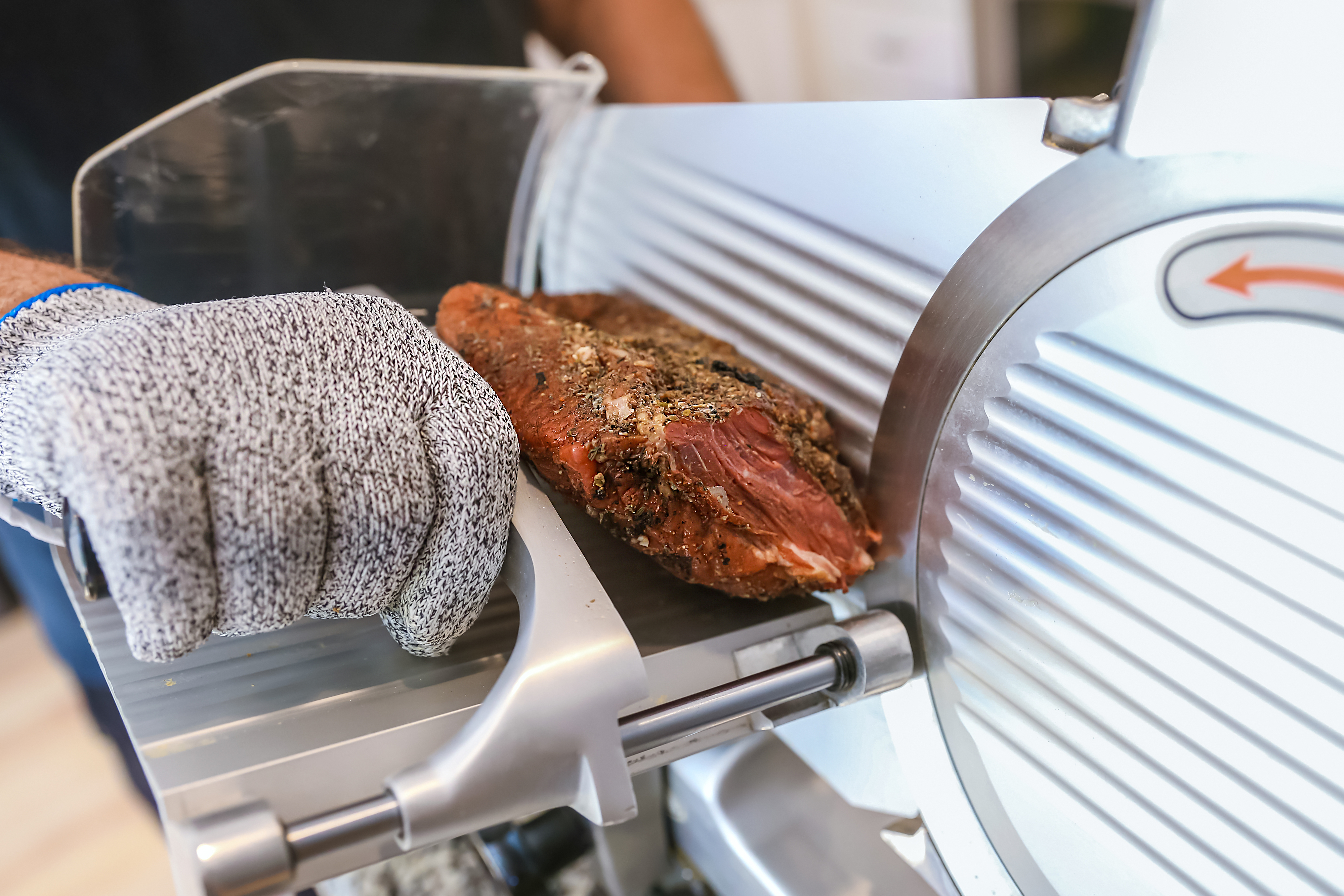 slicing beef on a deli slicer