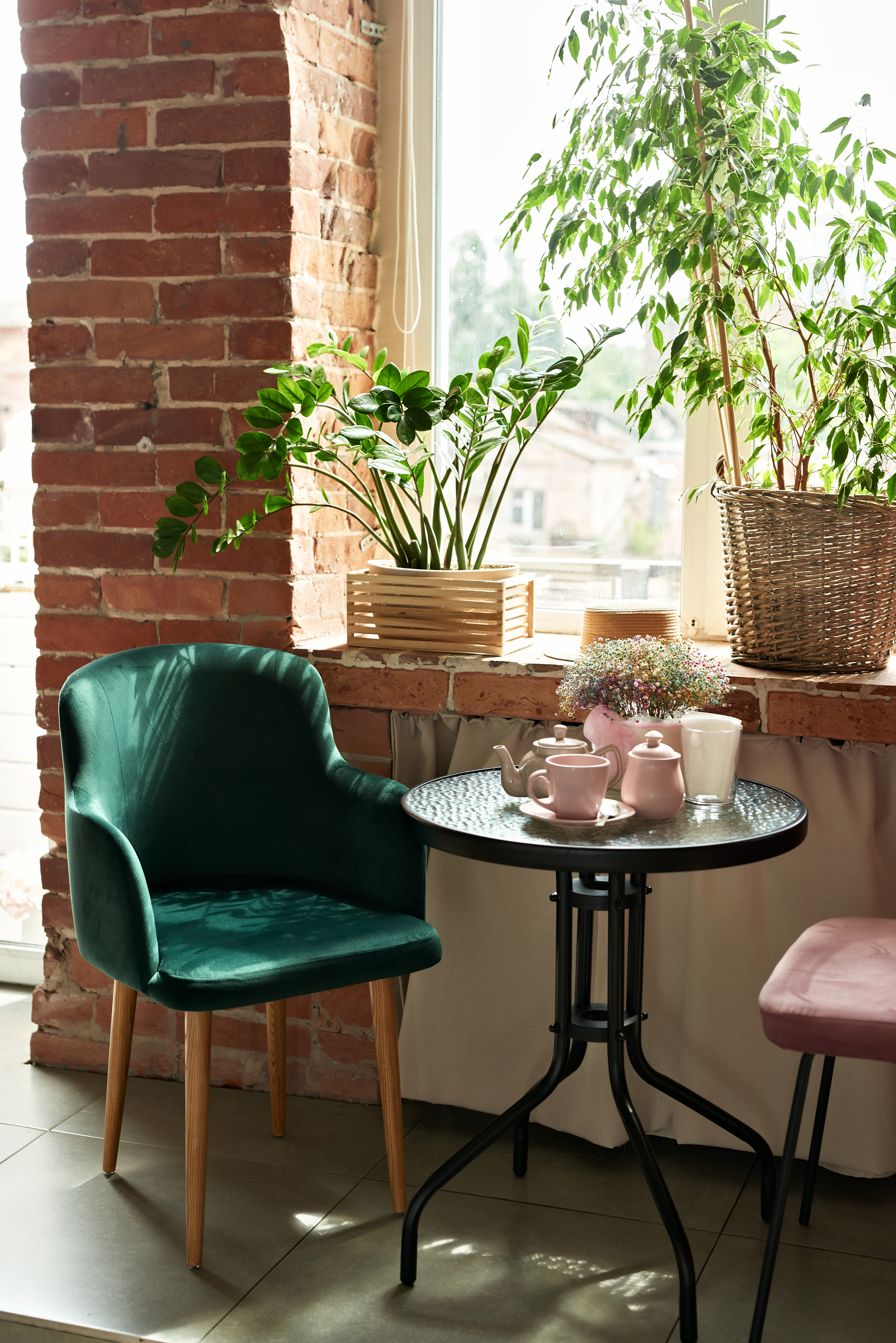 a cafe table with several plants near it