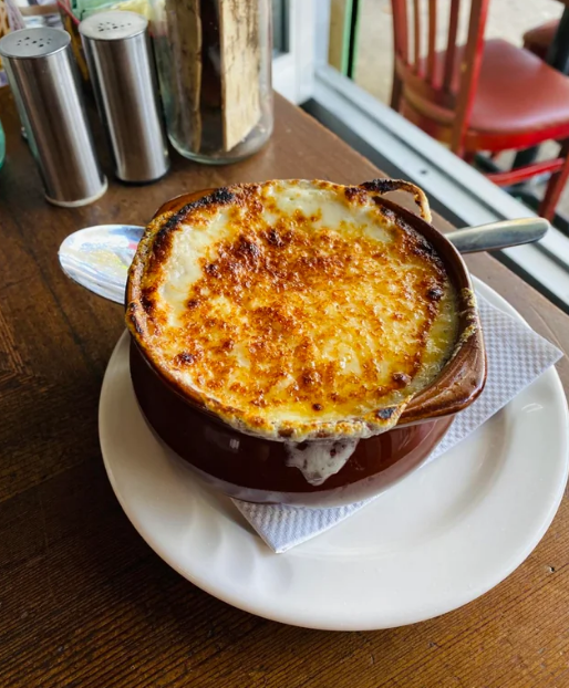 french onion soup at a restaurant in a crock