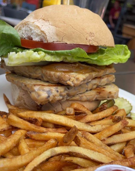 burger made out of tempeh between two buns at a restauarant