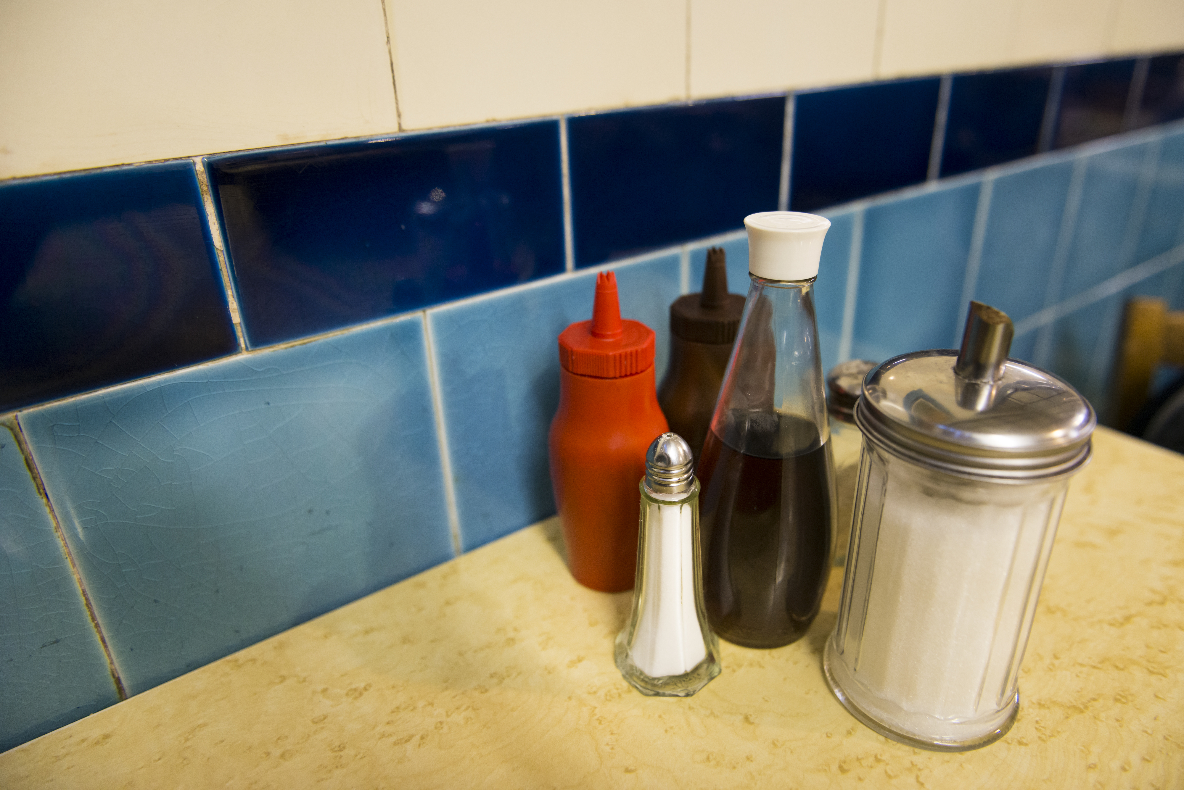 red bottle of ketchup at a restauarant