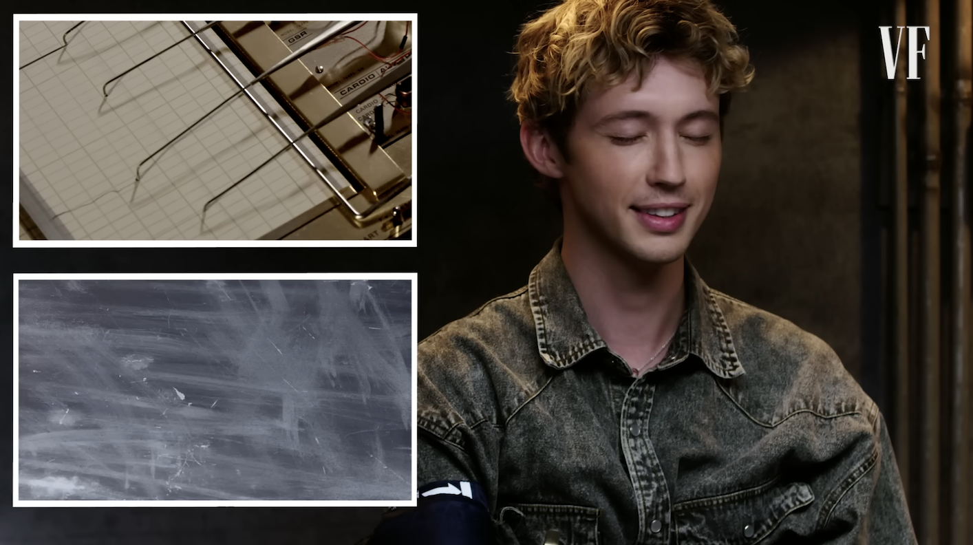 Close-up of Troye smiling with his eyes closed during the test