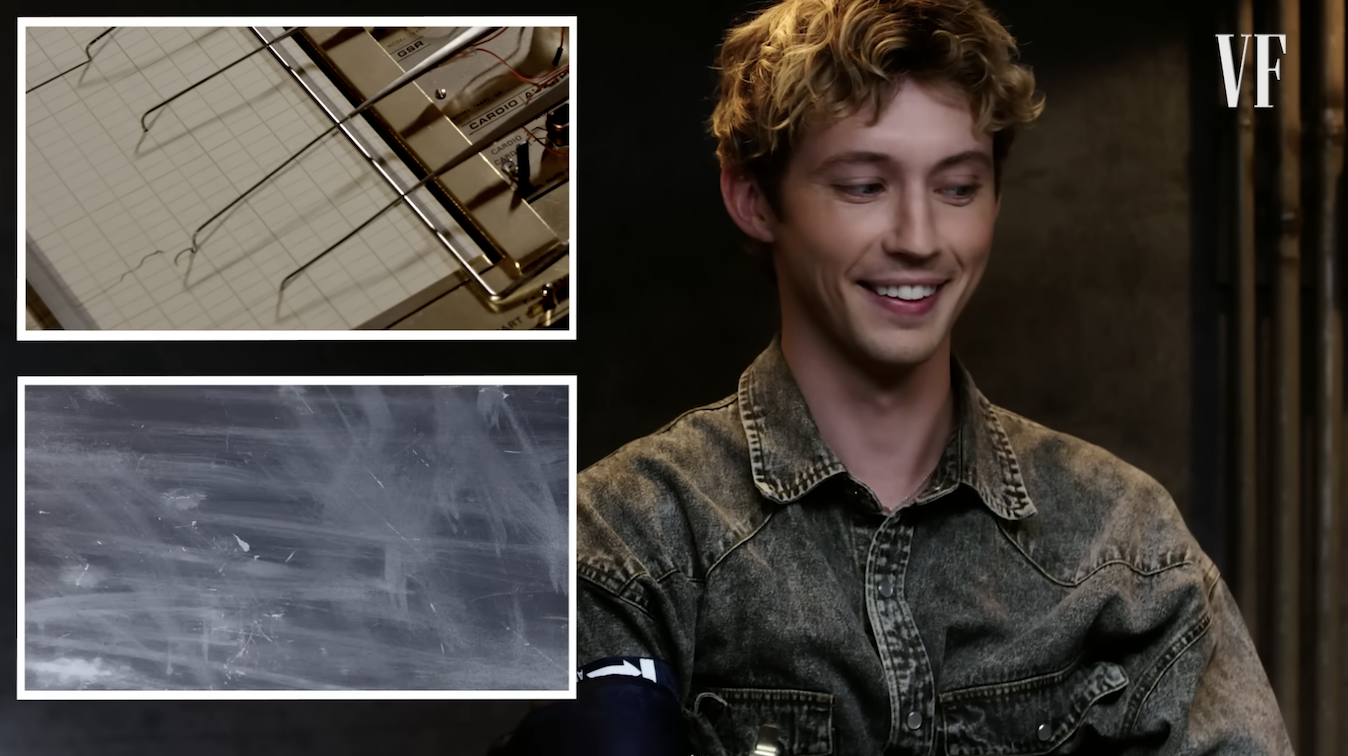 Close-up of Troye smiling and looking sideways during the test
