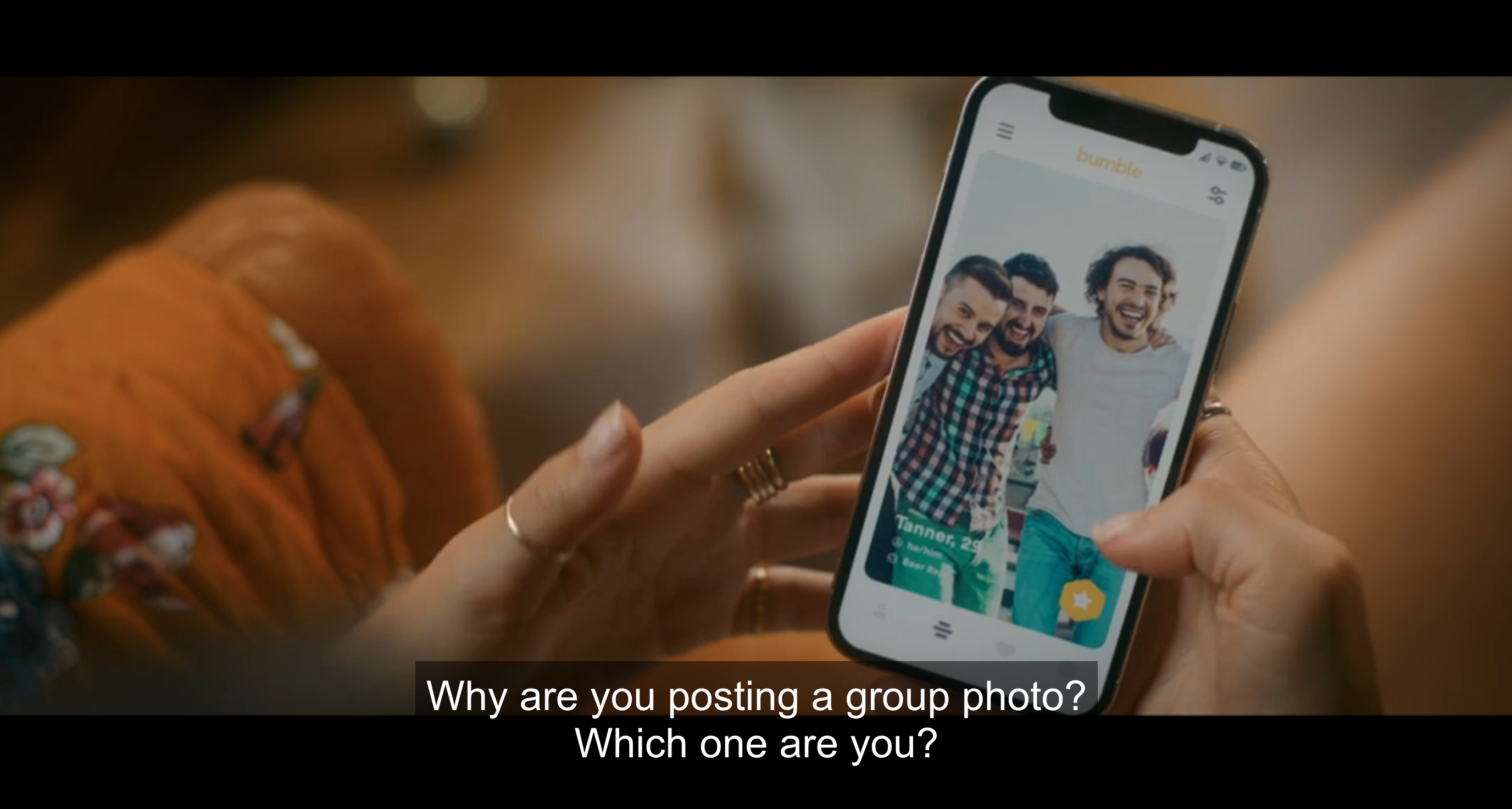 woman holding phone looking at group of three men on bumble and saying &#x27; why are you posting a group photo? which one are you?&#x27;