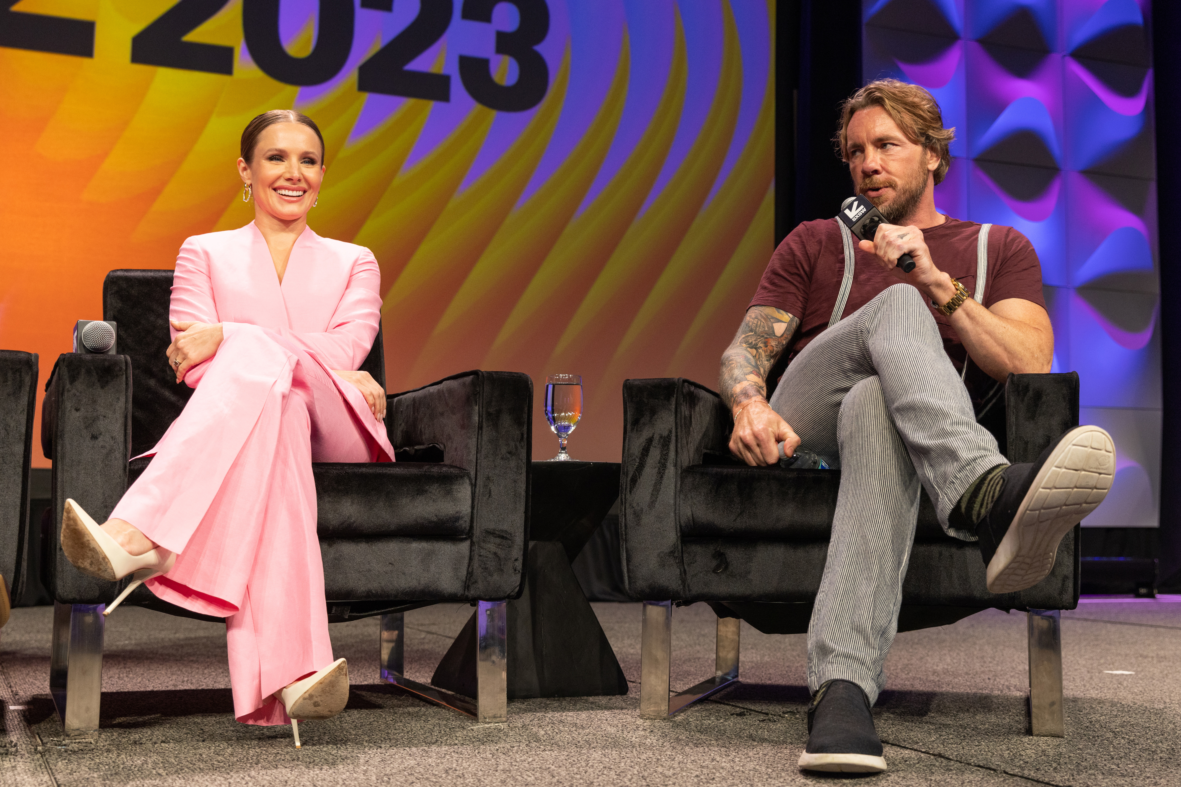 dax and kristen sitting on stage for a panel