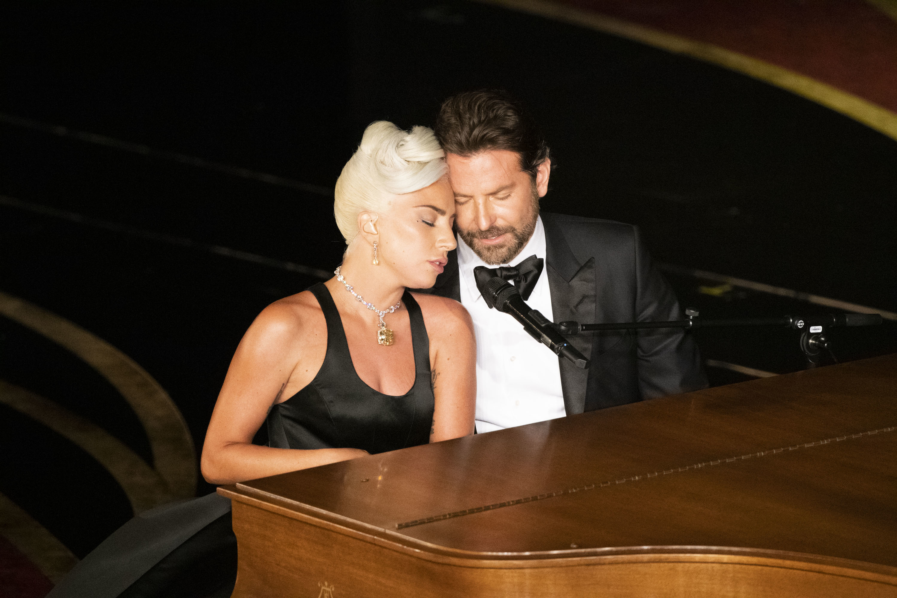 him and lady gaga singing at a piano