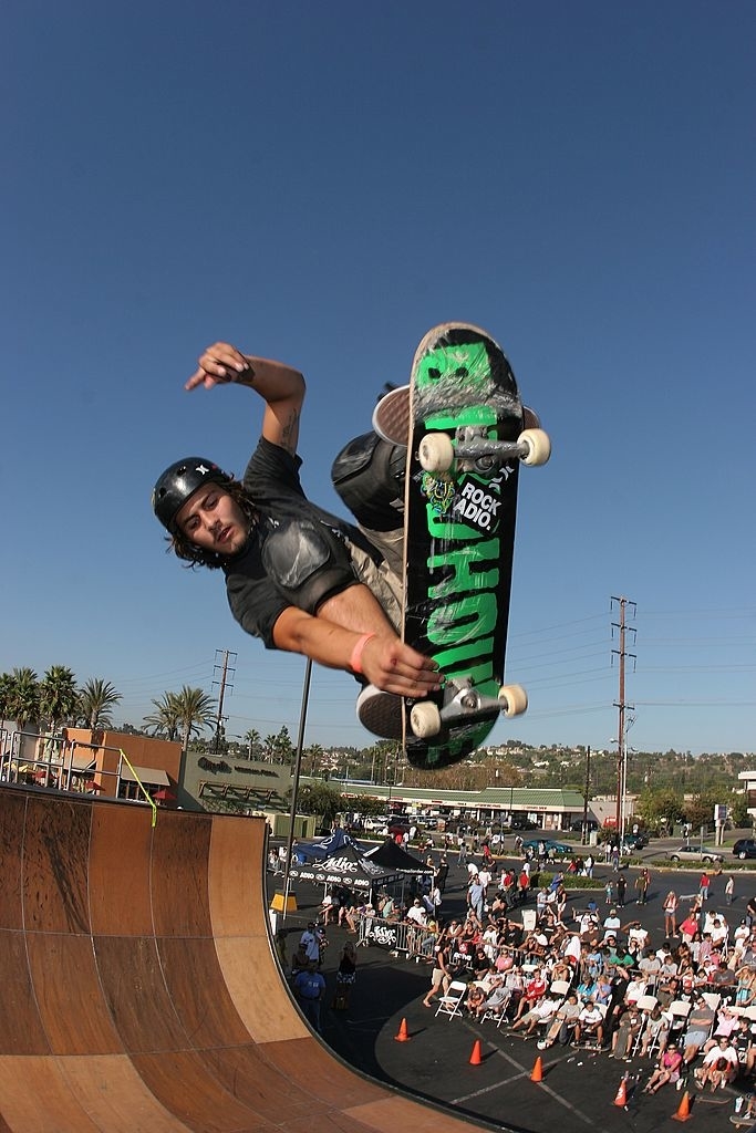 A skateboarder doing a move at a competition