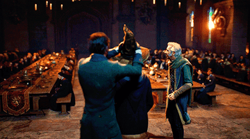 A young wizard accepts the sorting hat at the Grand Hall at Hogwarts