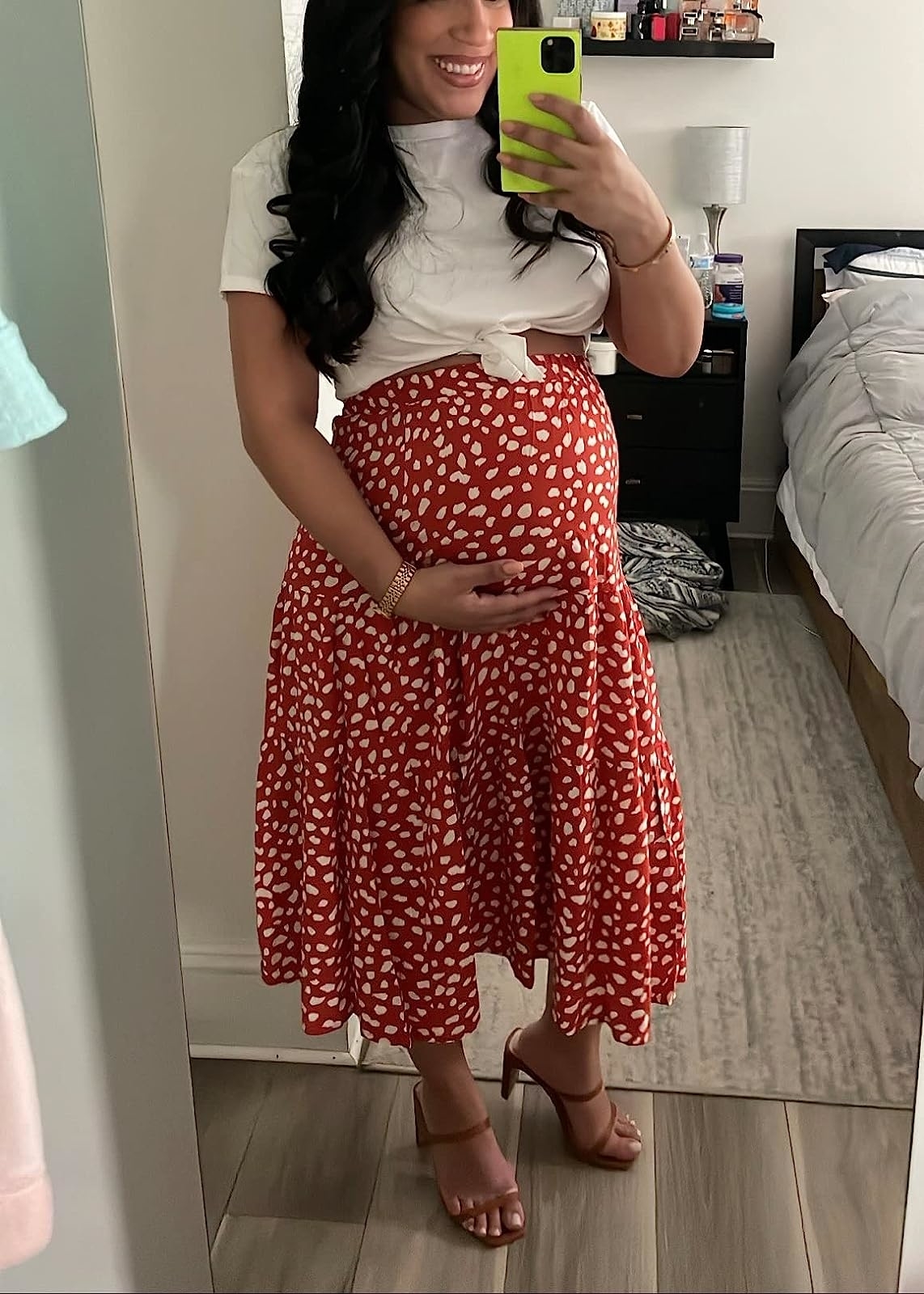 Reviewer wearing the red printed skirt with a white tee