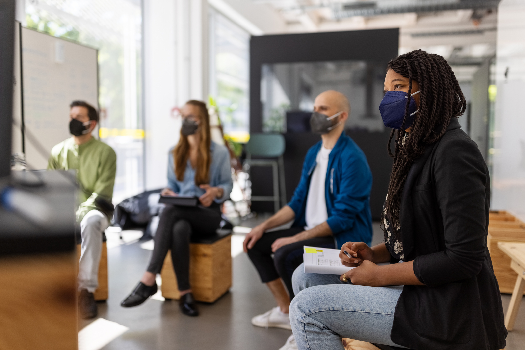 People wearing masks in a meeting
