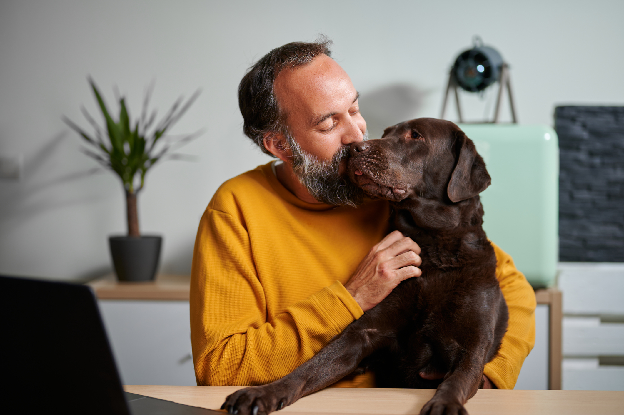 A man kissing his dog