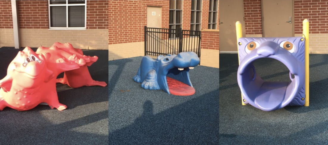 A very creepy children&#x27;s playground set up with three animals with their mouths wide open