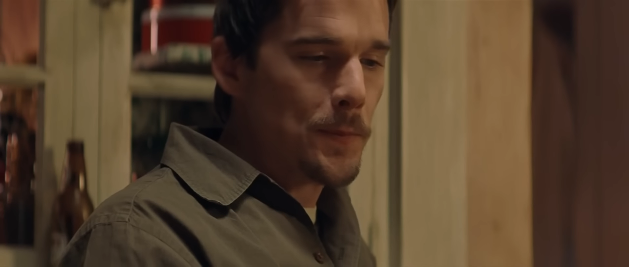 Ethan Hawke as Jake, looking concerned while playing poker in Training Day