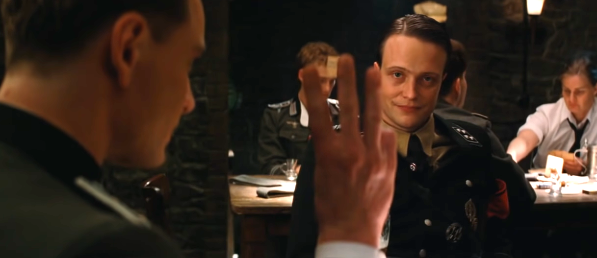 Michael Fassbender in Inglourious basterds holding up three fingers