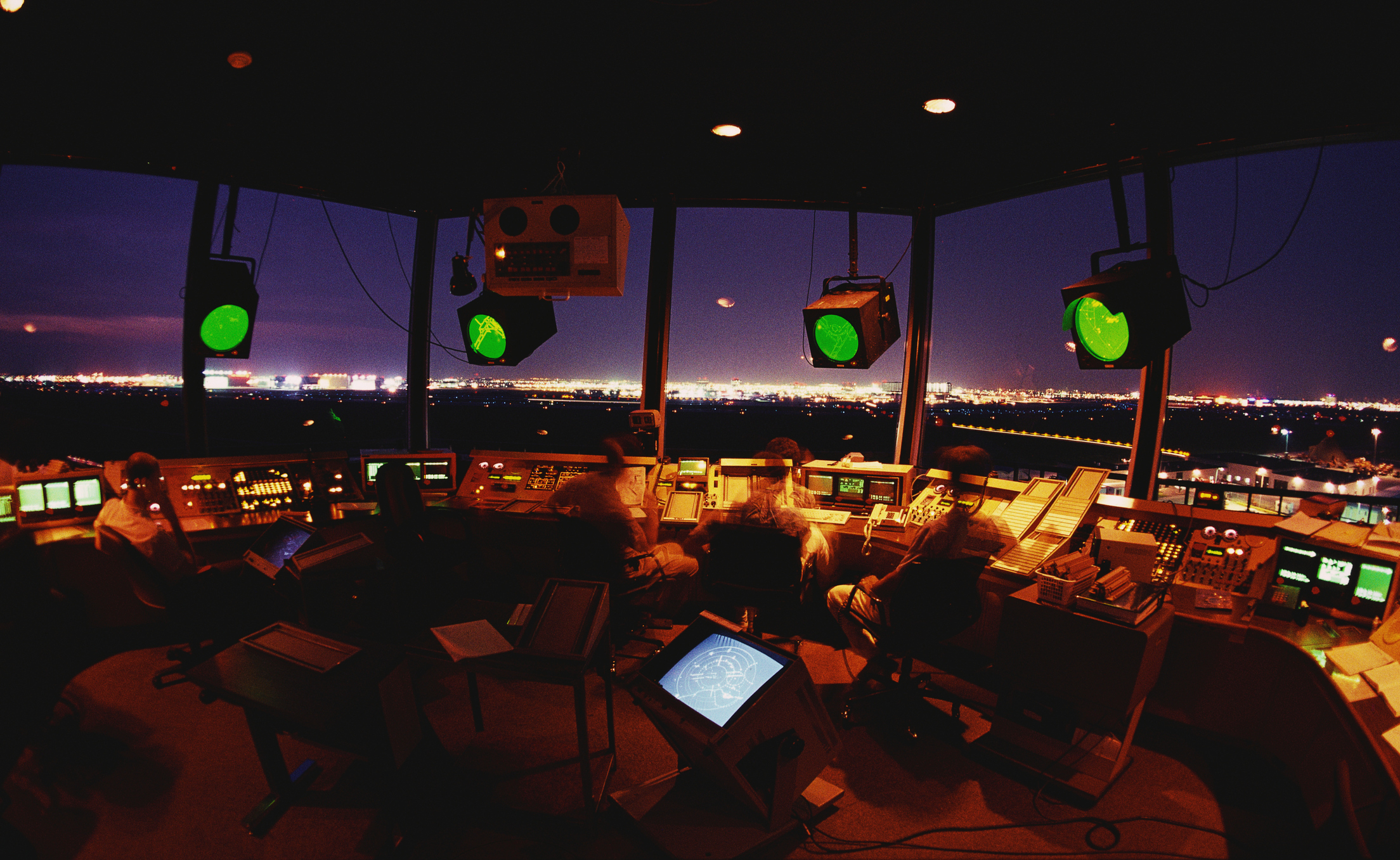 A crew of air traffic controllers are working in the tower
