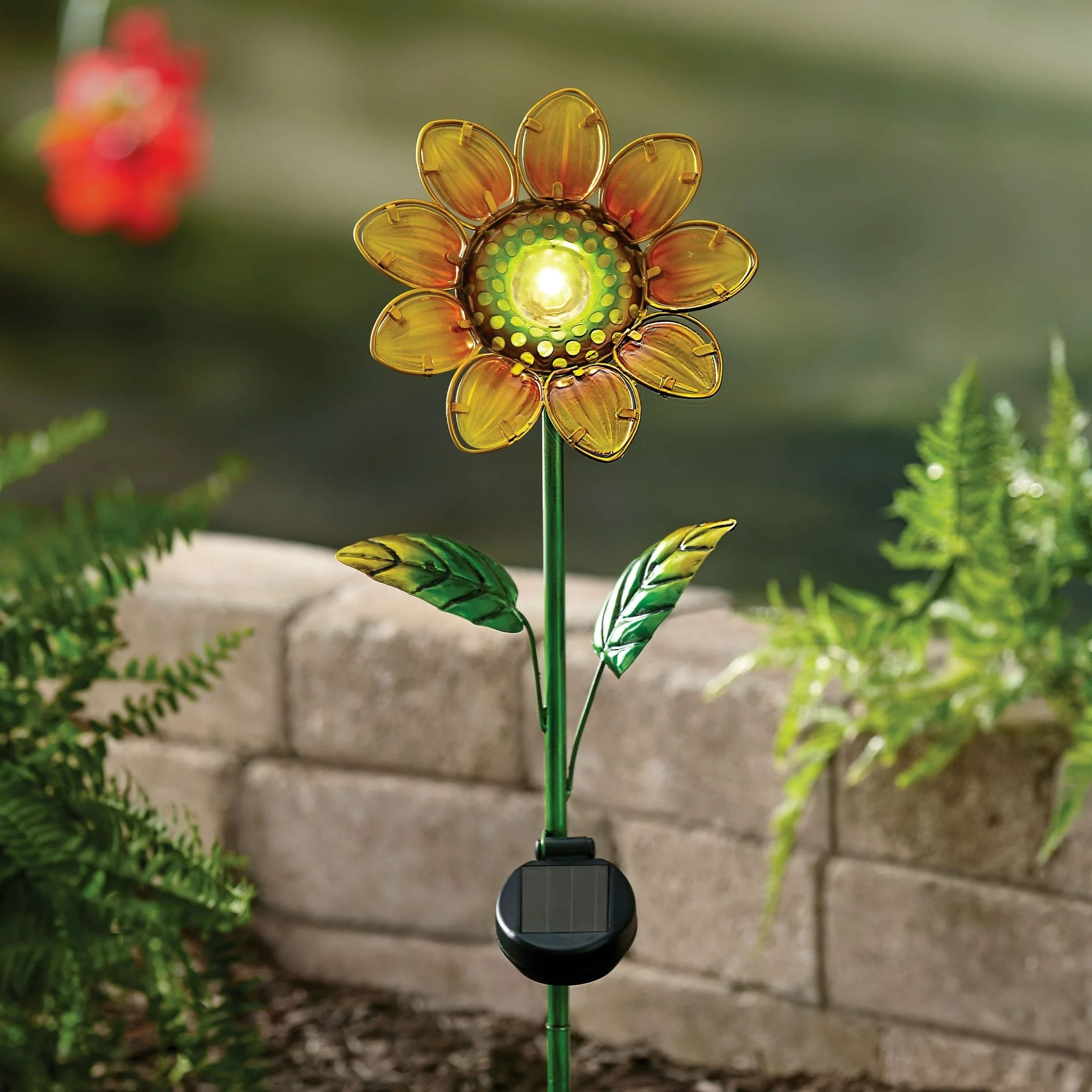 The garden stake with a mini solar panel attached at the stem