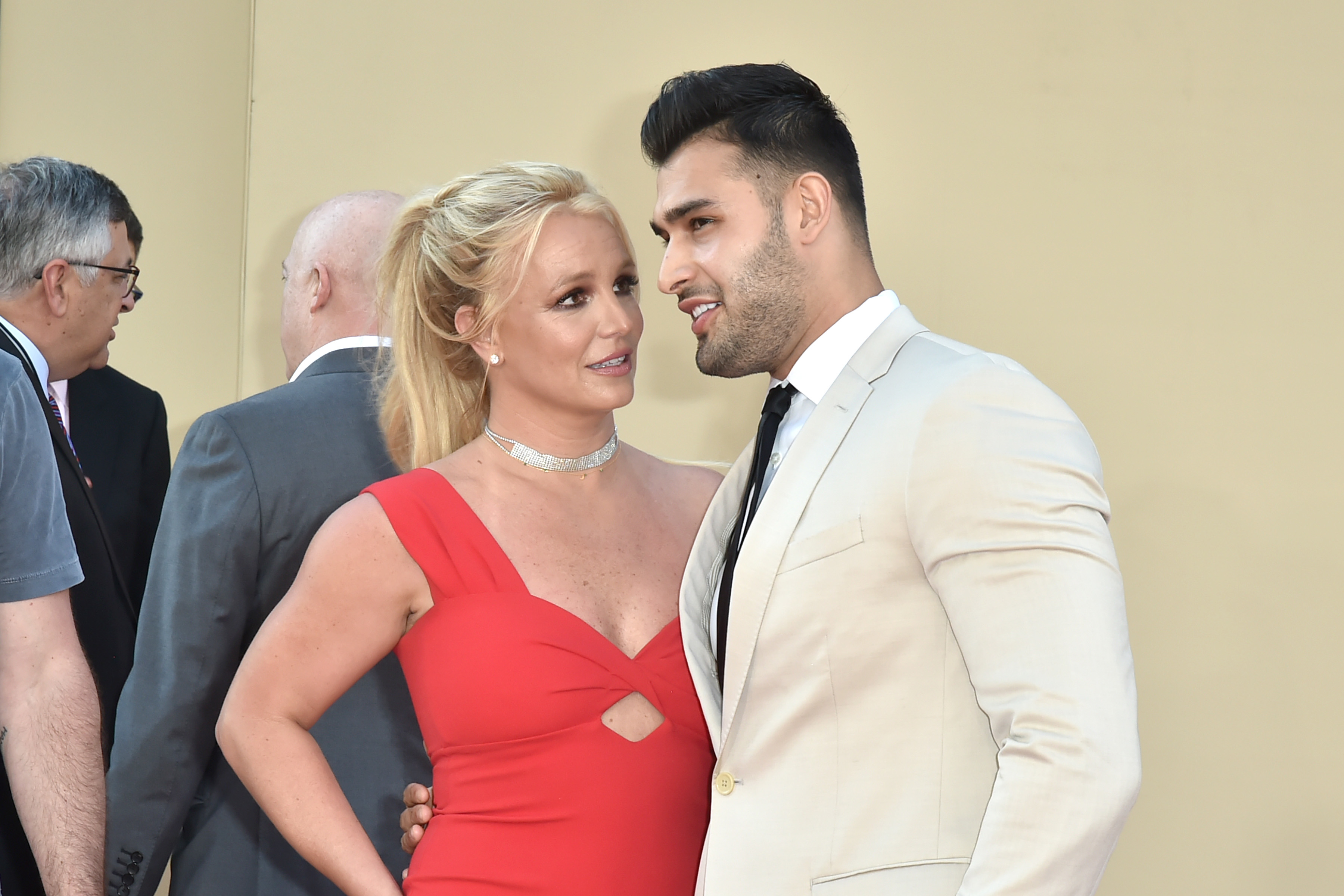 Close-up of Britney looking at Sam, who has his arm around her waist