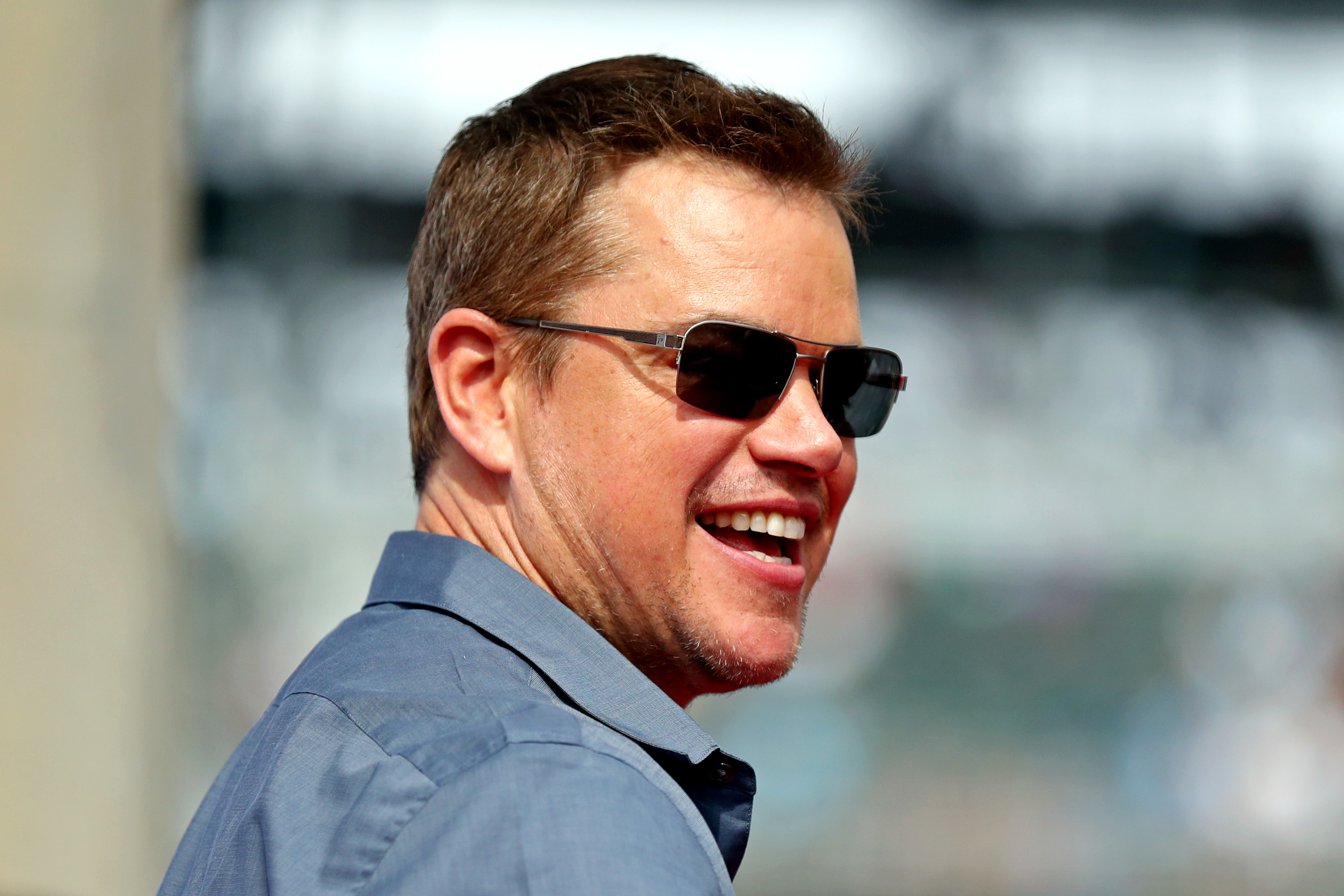 Closeup of Matt Damon smiling and wearing sunglasses