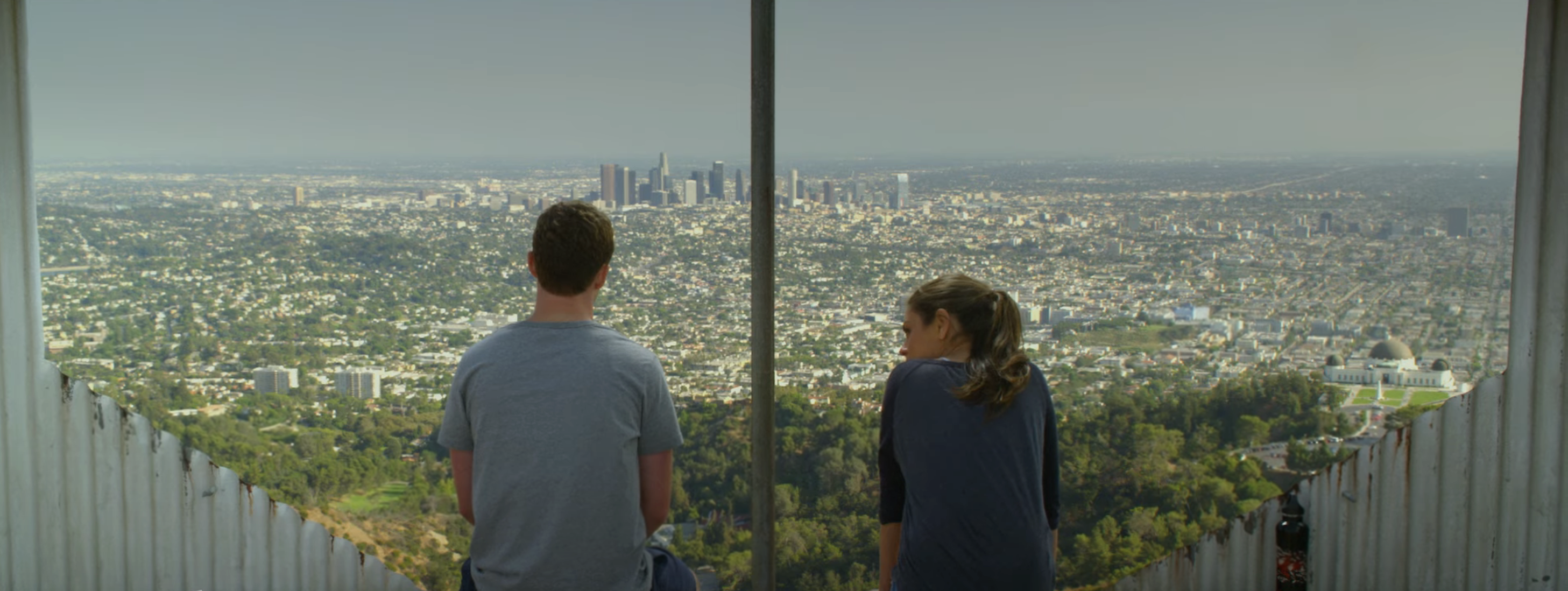 Two people looking out at the Los Angeles skyline