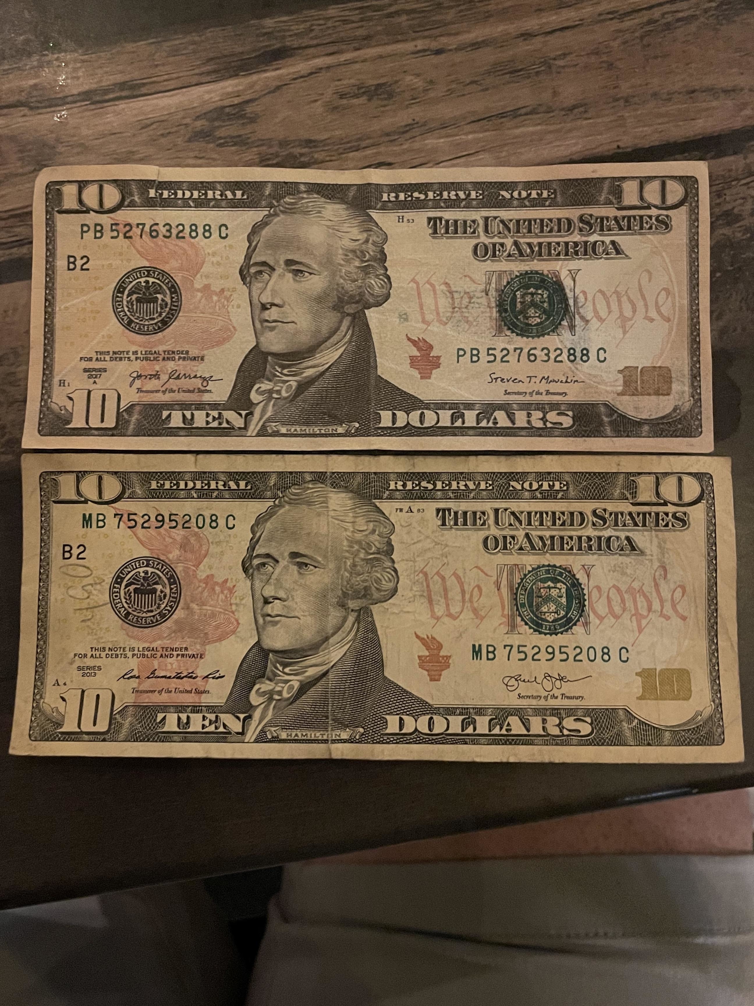 A counterfeit bill next to a real one