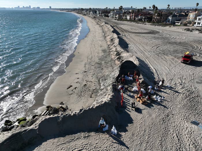 People building a sand berm