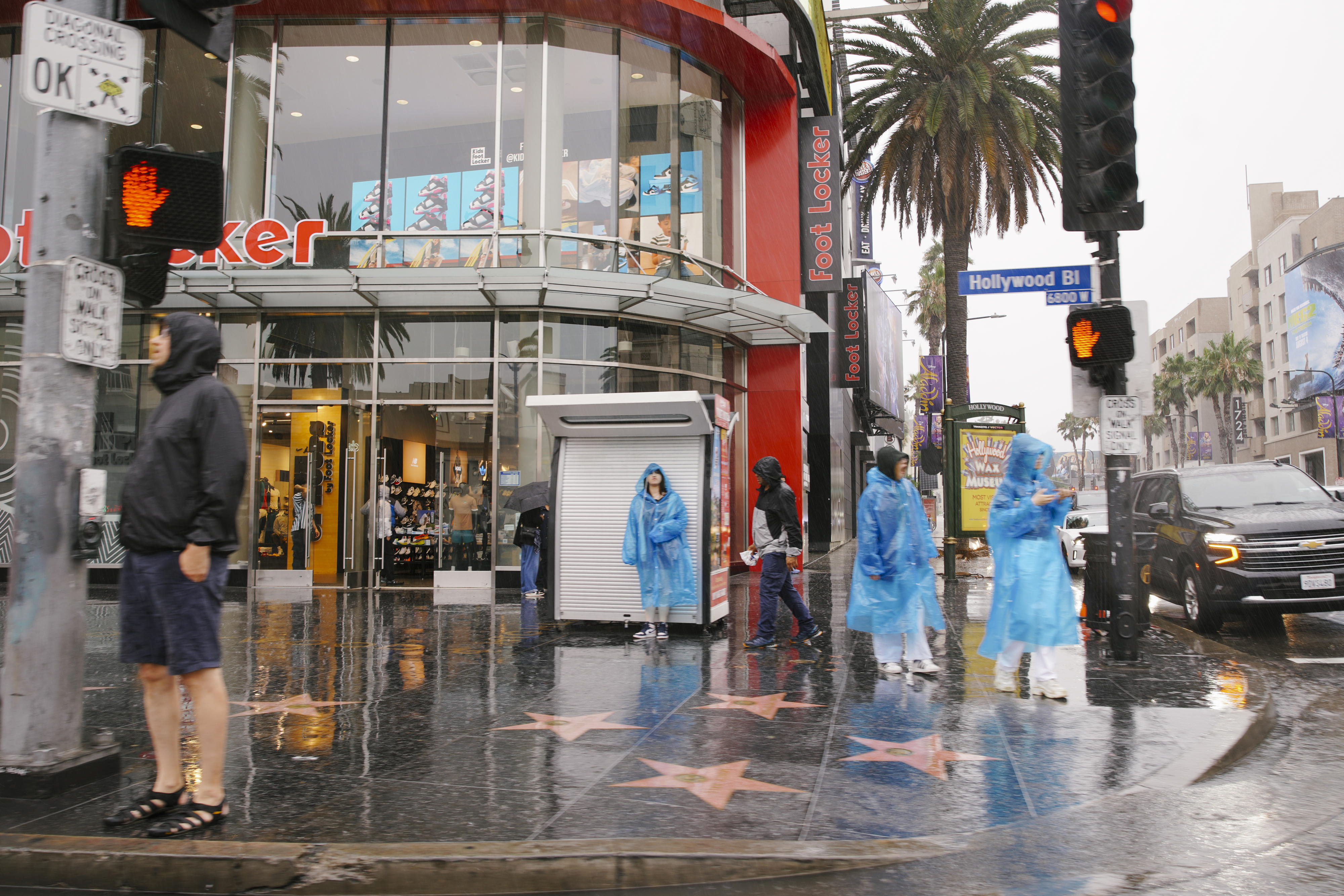 People walking on the sidewalk in the rain