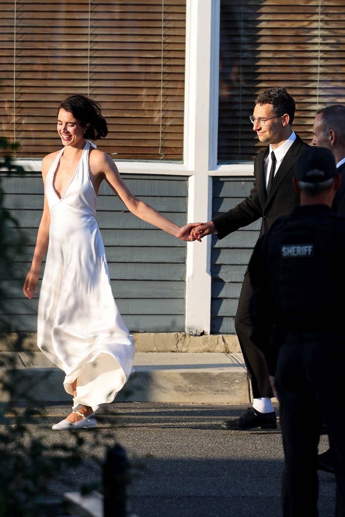 Closeup of Margaret Qualley and Jack Antonoff holding hands as they walk