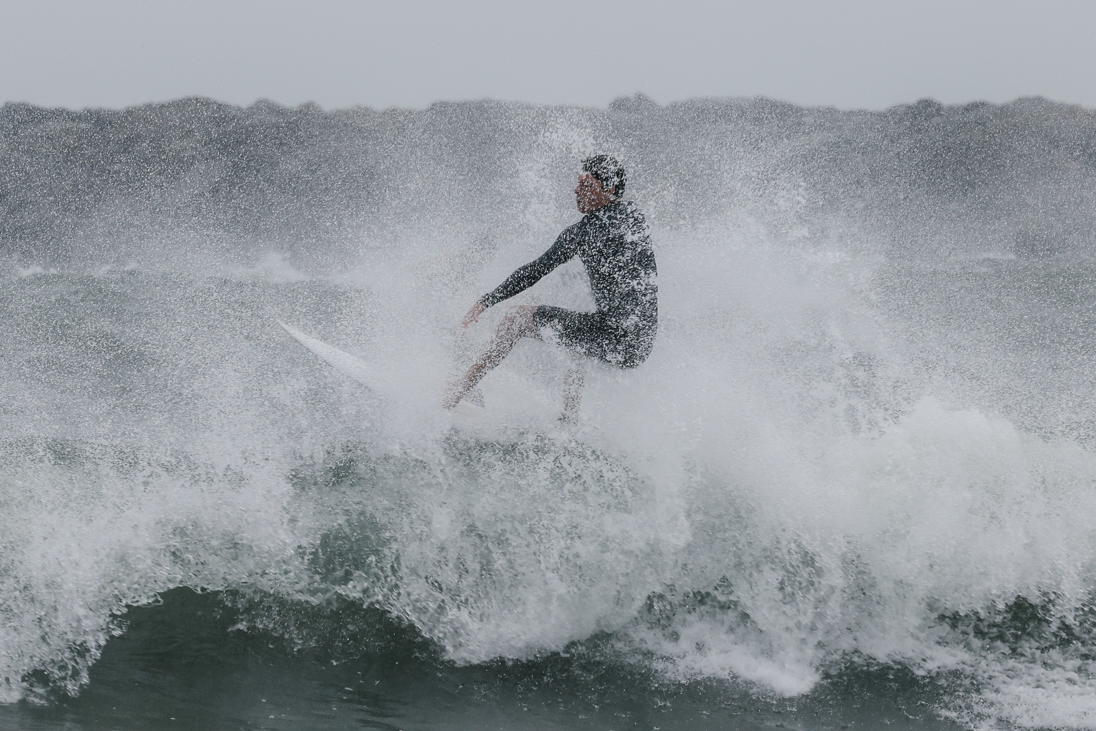 A person surfing in a storm