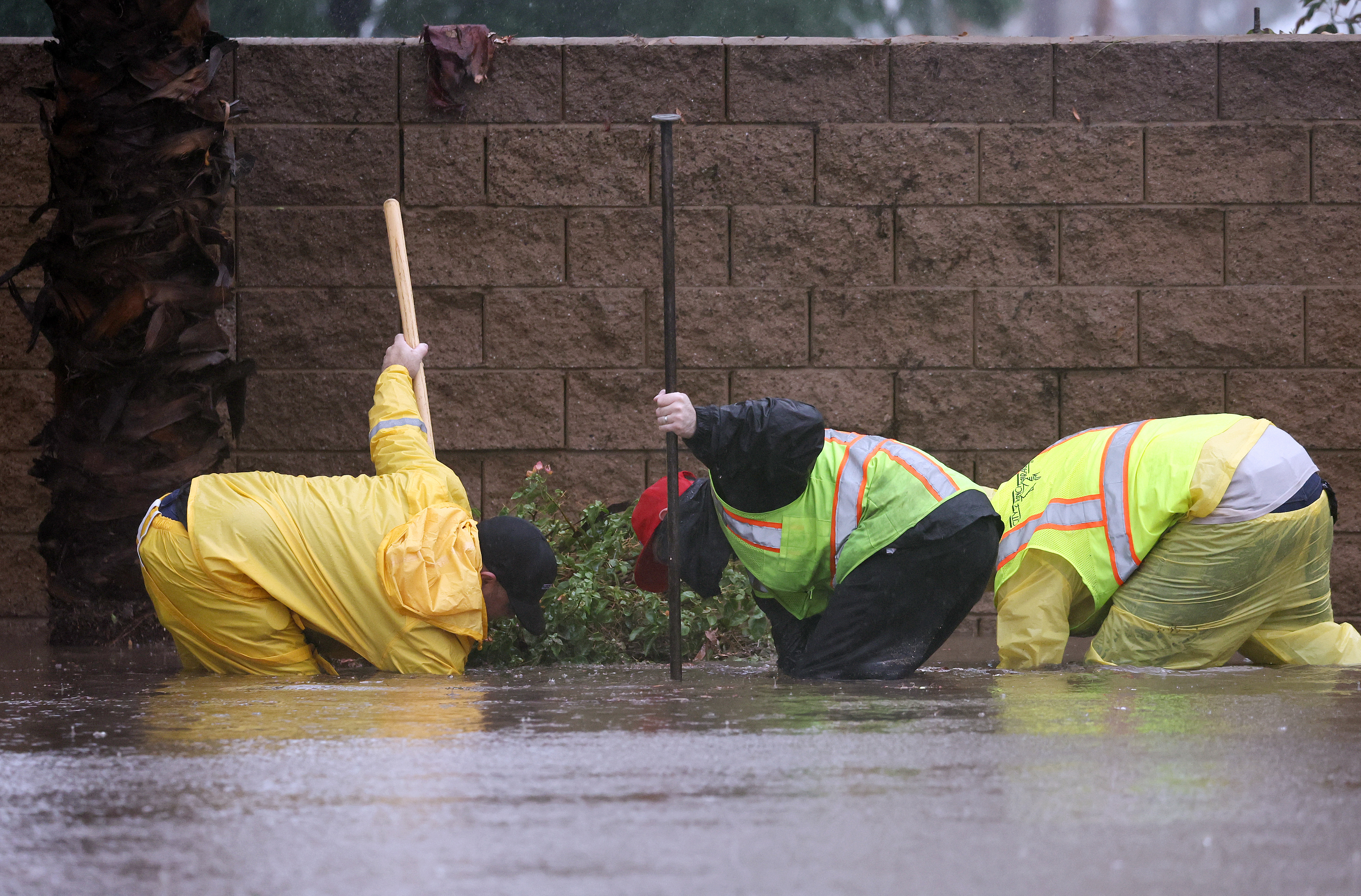Workers clearing out a storm drain