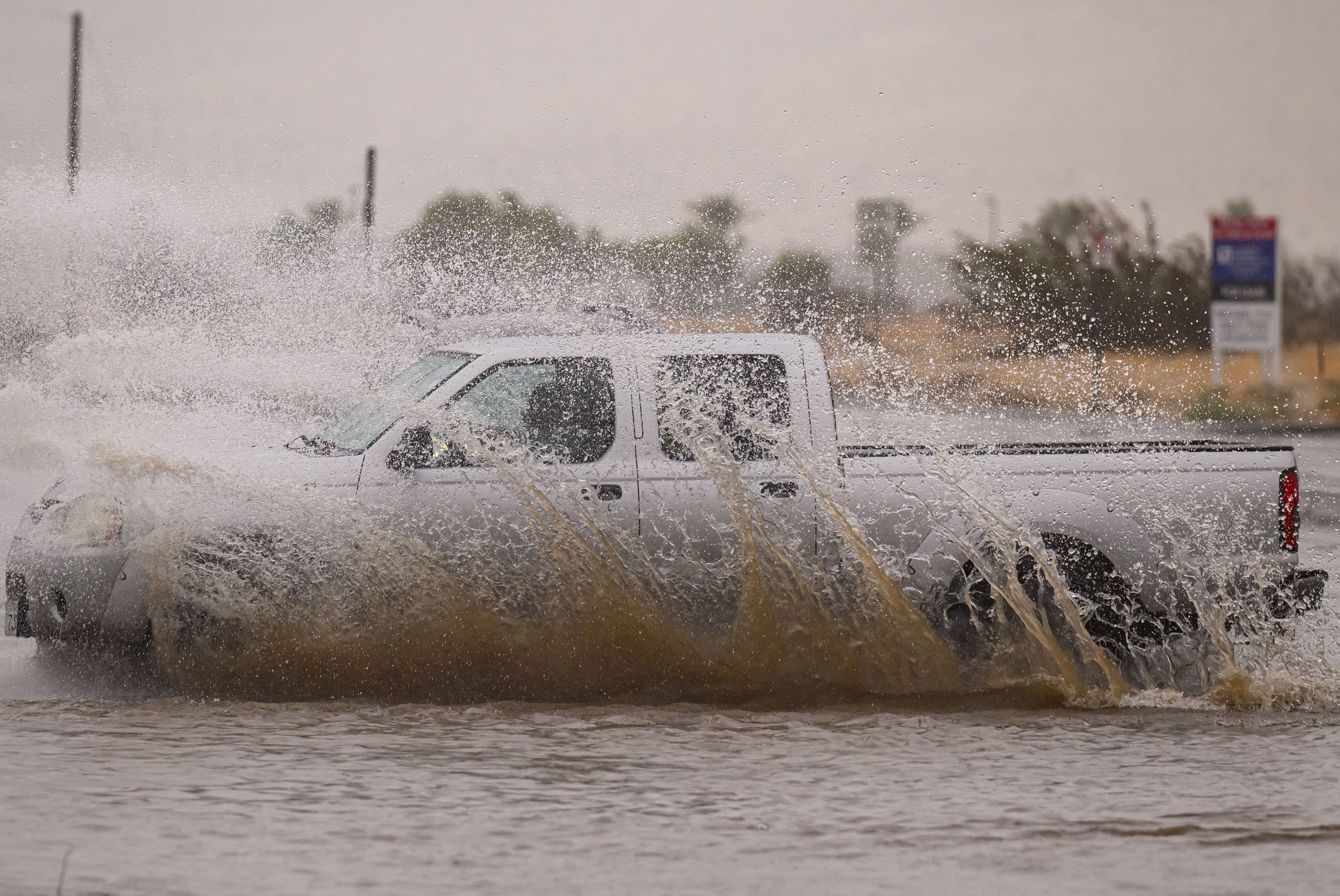 A truck driving through a flood