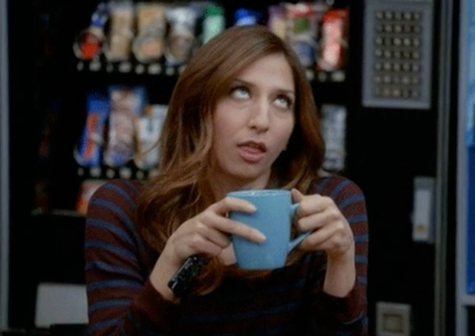A woman rolling her eyes while drinking coffee