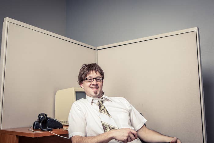 A man sitting in a cubicle