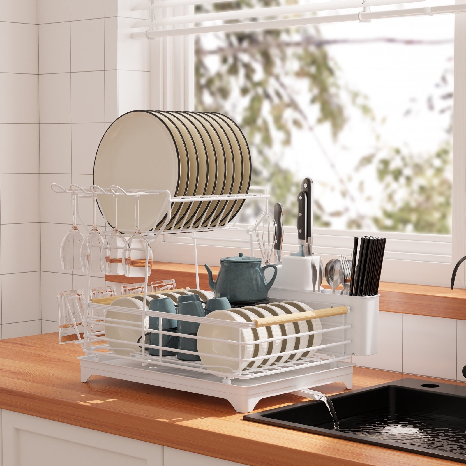 A white dish rack on a wooden countertop.