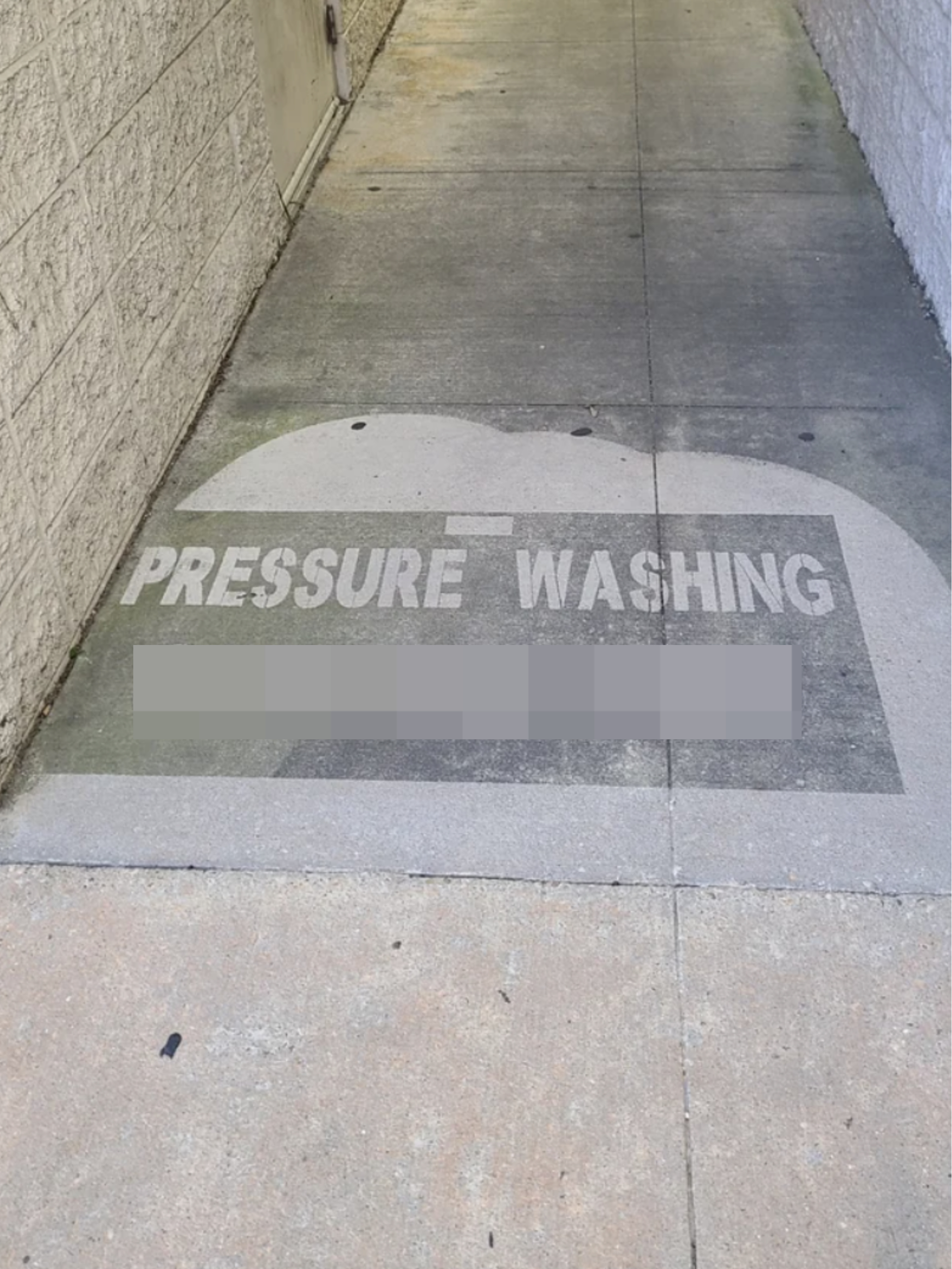sidewalk pressure-washed in one section to give out business phone number