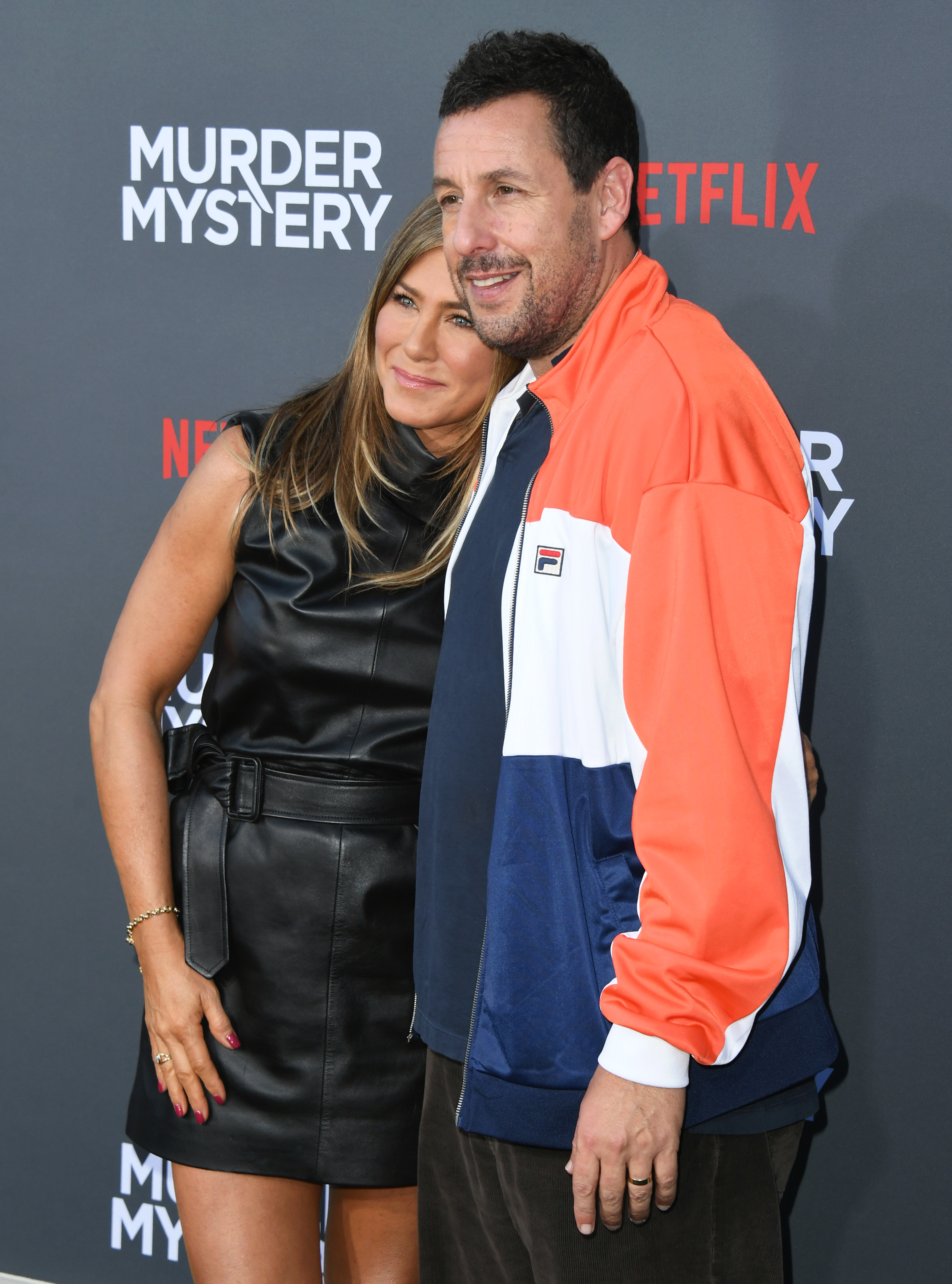 Jennifer Aniston and Adam Sandler hugging on the red carpet